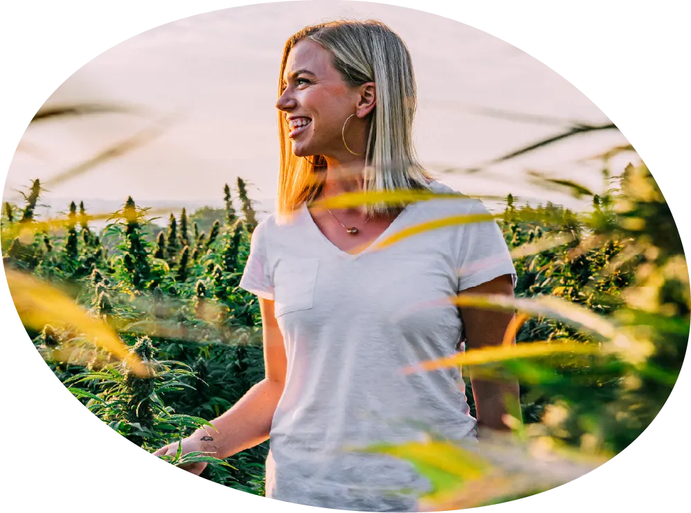 Woman walking through hemp field